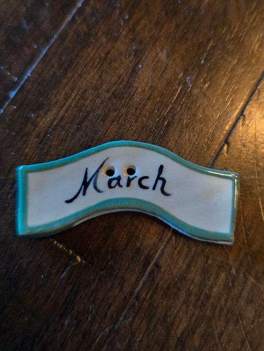 Albe Creation's, Inc. - March Ceramic Button