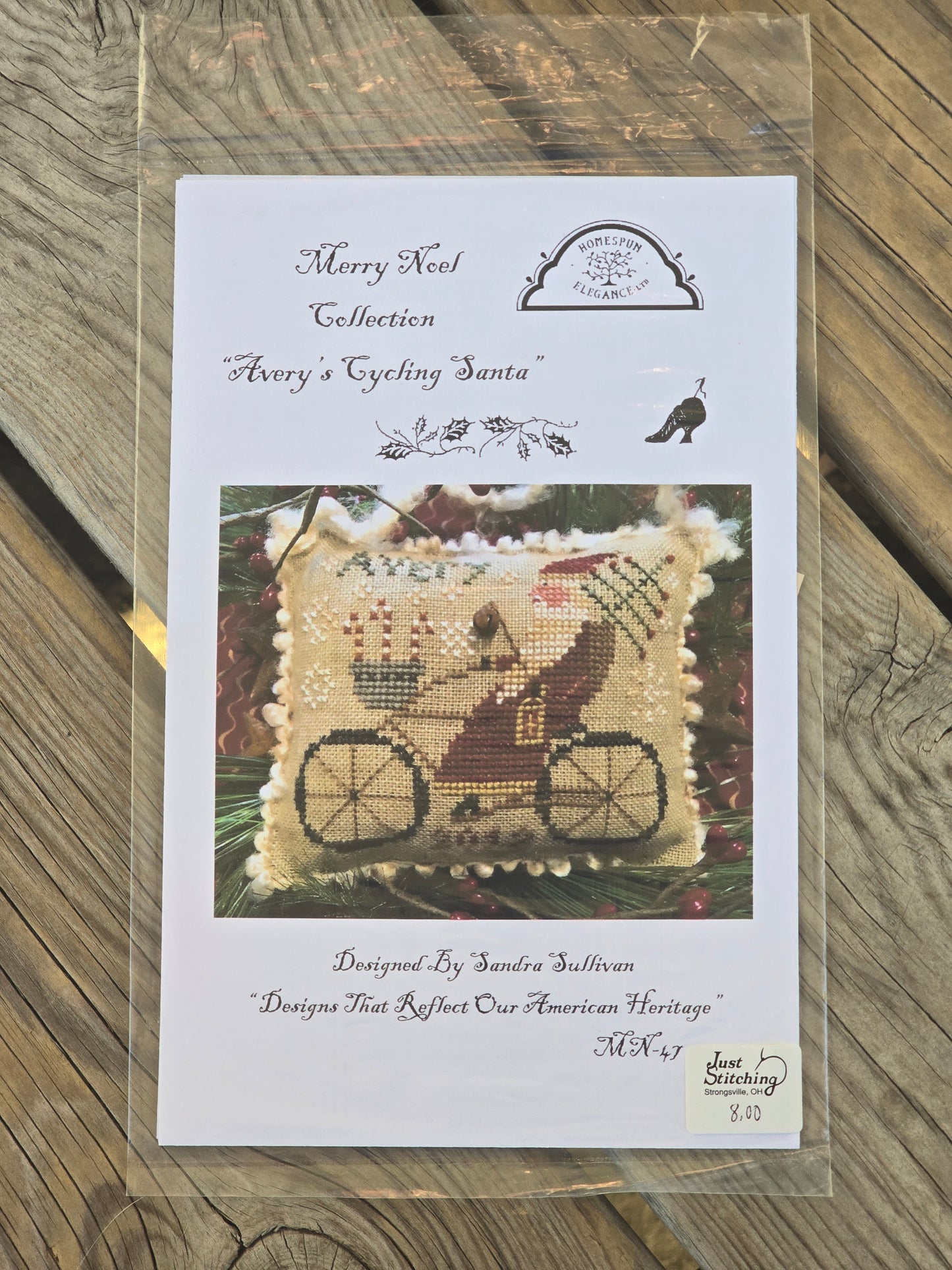 Homespun Elegance - Merry Noel Collection - Avery's Cycling Santa - Cross Stitch Pattern