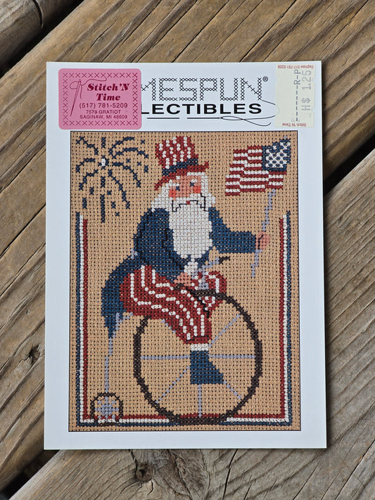 Homespun Collectibles - Patriotic Santa on Unicycle - #53 - Cross Stitch Pattern