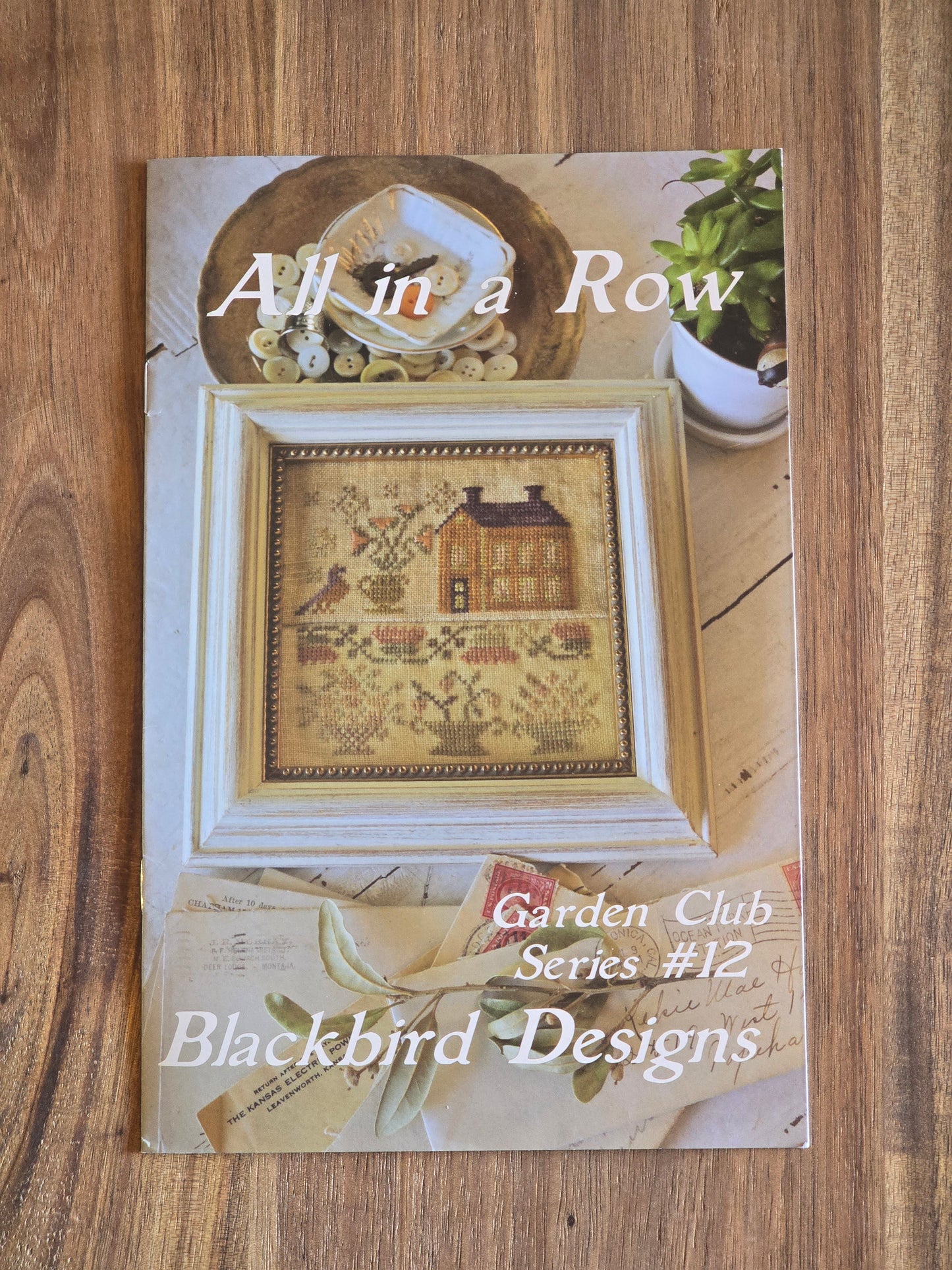 Blackbird Designs - All in a Row - Garden Club Series 12 - Cross Stitch Pattern